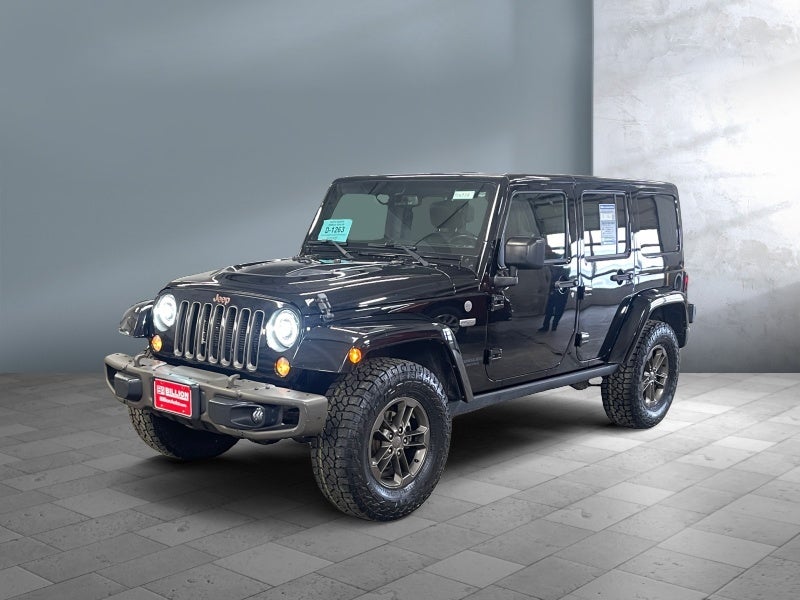 2016 Jeep Wrangler Unlimited Sahara in Black — front three-quarter view